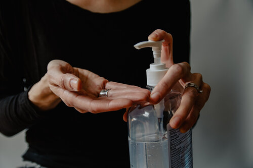 Lady using hand sanitizer