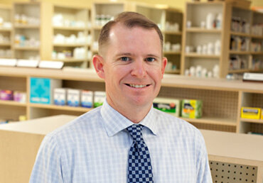Matt Roberts, Pharmacist and owner standing in his pharmacy