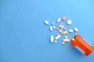 Medication spread out on a blue background