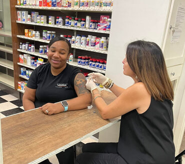 Pharmacist giving a vaccination to a patient